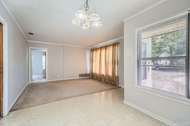 carpeted spare room featuring crown molding, a textured ceiling, and a chandelier