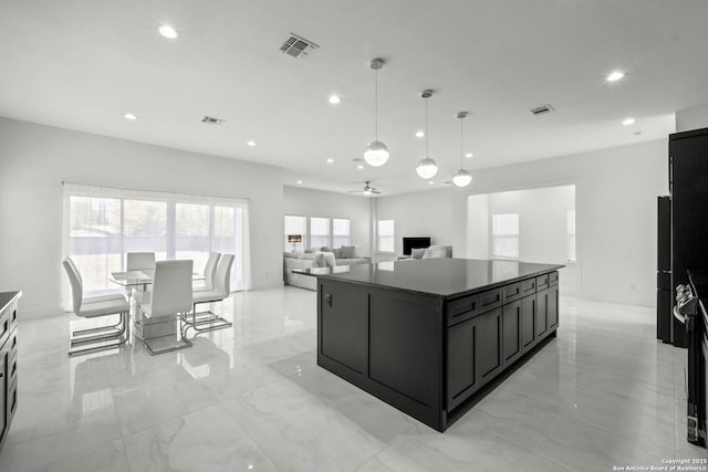 kitchen with a kitchen island, pendant lighting, and ceiling fan