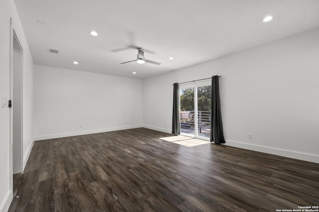 empty room with ceiling fan and dark hardwood / wood-style flooring