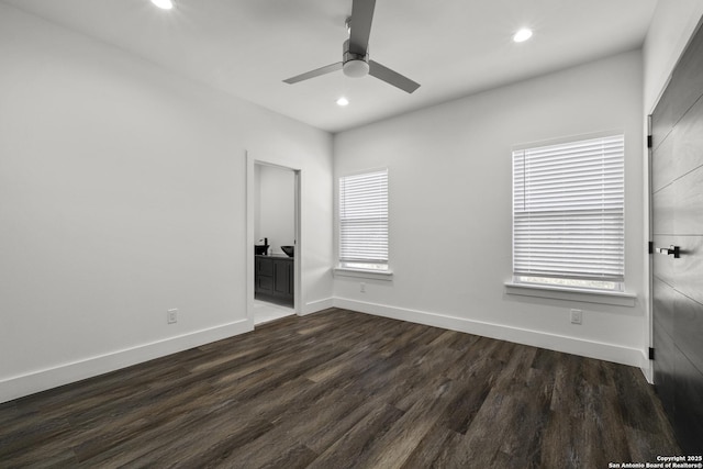 unfurnished bedroom with dark hardwood / wood-style flooring, multiple windows, and ceiling fan