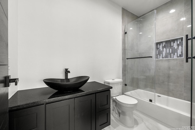 full bathroom featuring vanity, toilet, and combined bath / shower with glass door