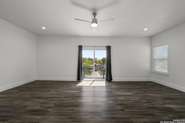 empty room with dark hardwood / wood-style flooring and ceiling fan