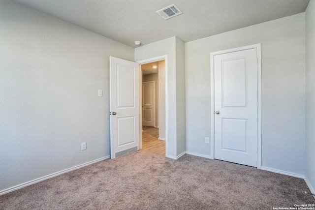 unfurnished bedroom with light carpet