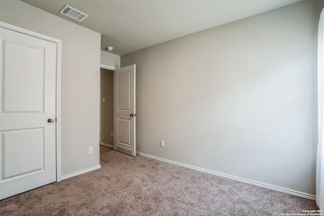 unfurnished bedroom featuring light carpet