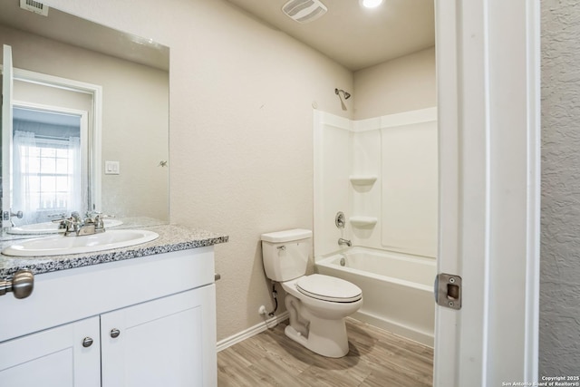 full bathroom with vanity, toilet, hardwood / wood-style floors, and shower / bathing tub combination