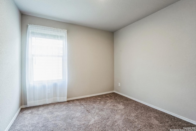 unfurnished room featuring plenty of natural light and light carpet