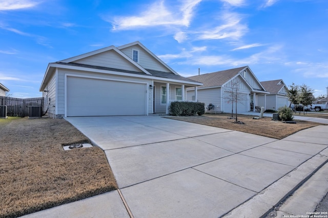 ranch-style home featuring cooling unit and a garage