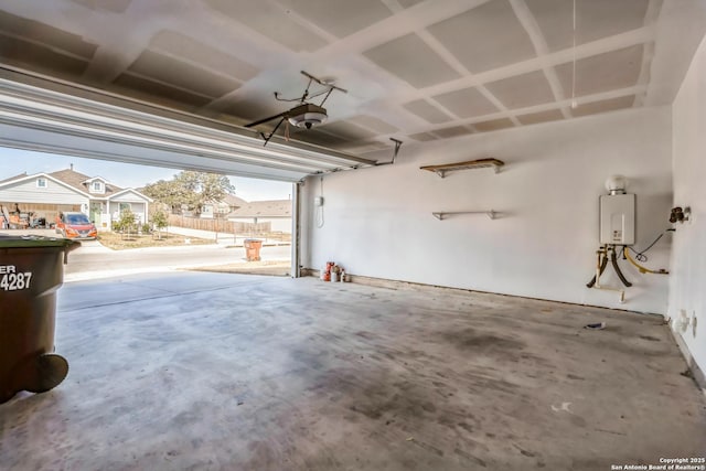 garage featuring a garage door opener and water heater