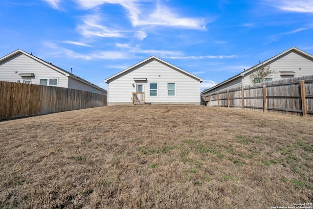 back of house featuring a lawn