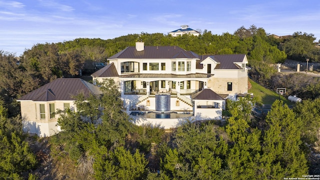 rear view of property featuring a gazebo and a patio area