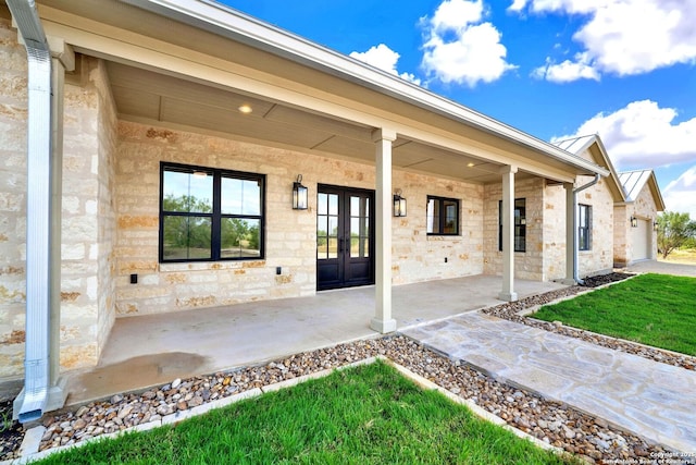 view of exterior entry featuring french doors