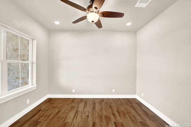 spare room featuring wood-type flooring and ceiling fan