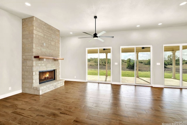 unfurnished living room with a fireplace and ceiling fan