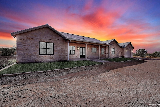 view of front of house featuring a garage and a lawn