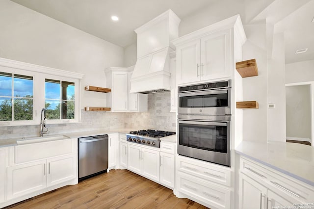 kitchen featuring appliances with stainless steel finishes, sink, and white cabinets