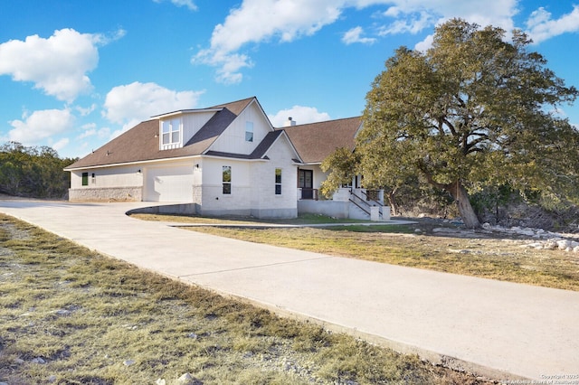 view of front of home with a garage and a front lawn