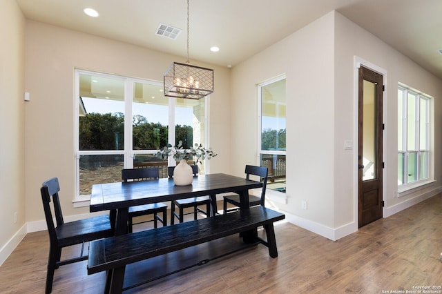 dining space featuring a notable chandelier and hardwood / wood-style flooring