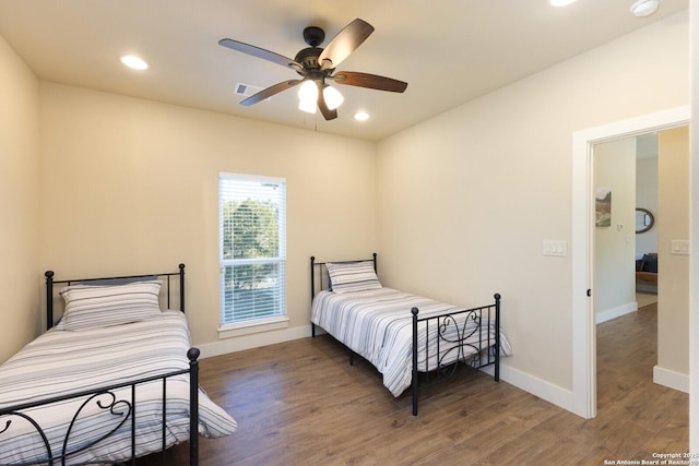 bedroom with dark wood-type flooring and ceiling fan