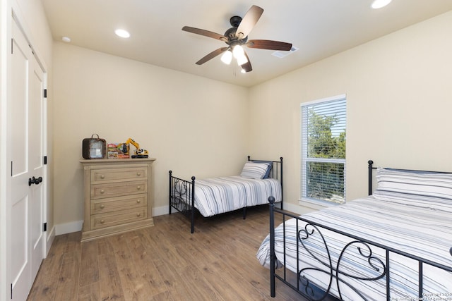 bedroom with wood-type flooring and ceiling fan