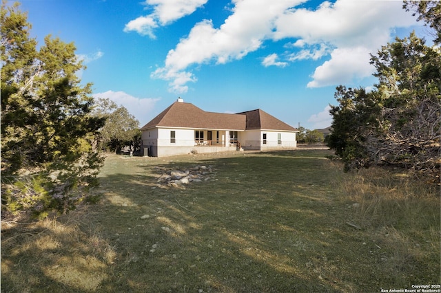 back of house with a lawn