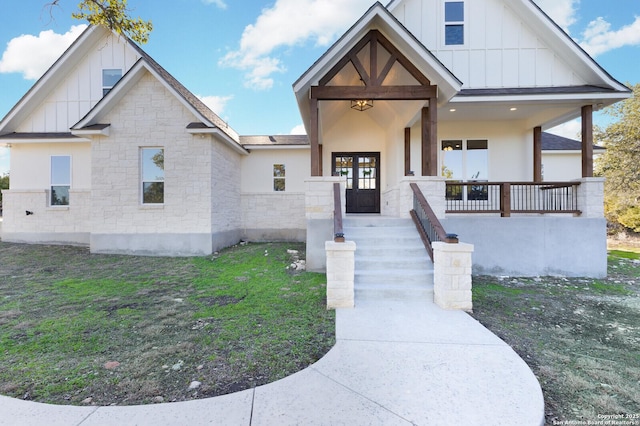 view of front of house featuring a front yard and french doors