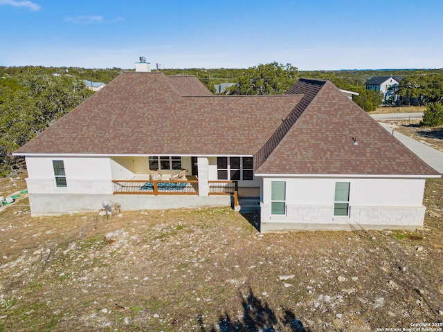 back of property with outdoor lounge area and a patio area