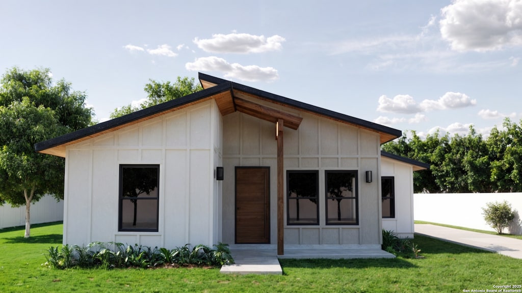 back of property featuring a lawn