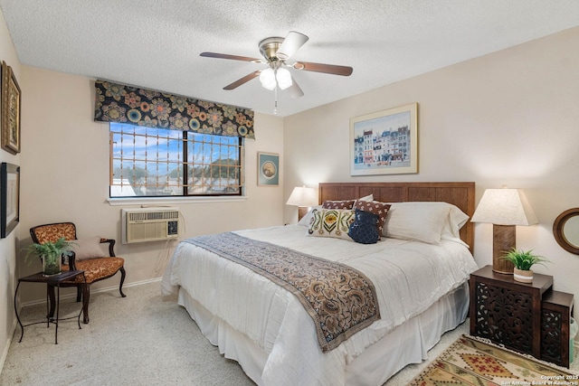 carpeted bedroom with a wall mounted air conditioner, a textured ceiling, and ceiling fan