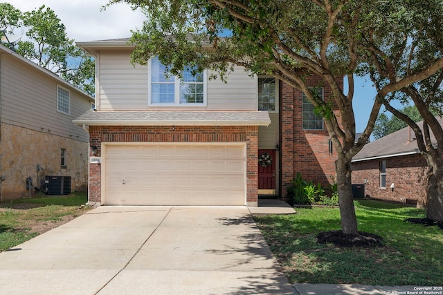 view of property with a garage, cooling unit, and a front yard