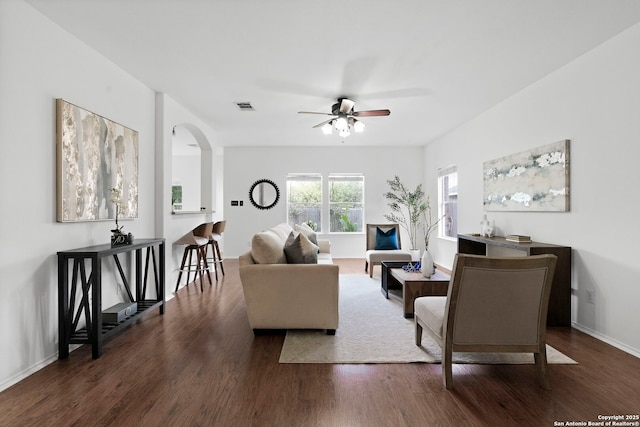 living room with dark hardwood / wood-style floors and ceiling fan