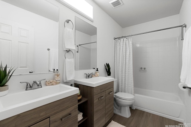 full bathroom featuring vanity, wood-type flooring, toilet, and shower / bath combo with shower curtain