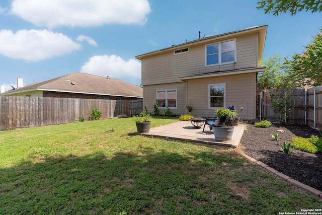 rear view of house featuring a patio, a lawn, and an outdoor fire pit