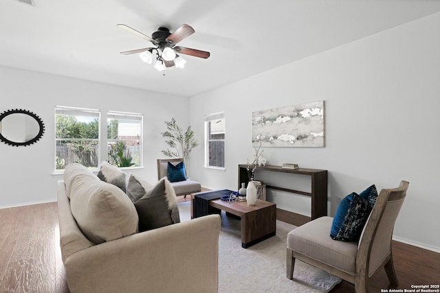 living room featuring ceiling fan and light hardwood / wood-style floors