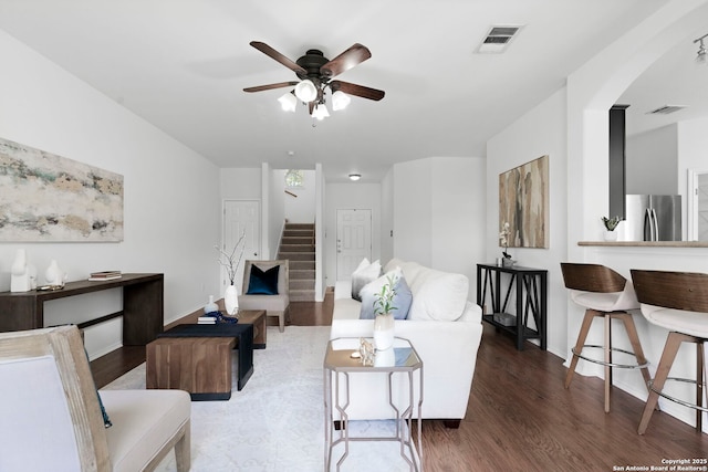 living room with ceiling fan and dark hardwood / wood-style floors