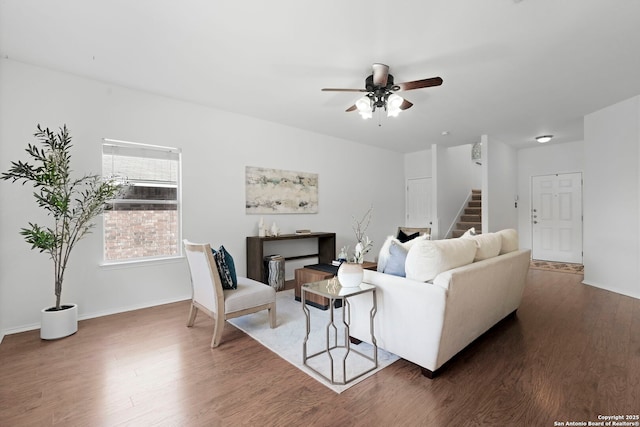 living room featuring ceiling fan and dark hardwood / wood-style flooring