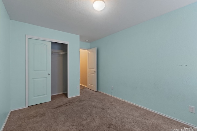 unfurnished bedroom with light colored carpet and a closet