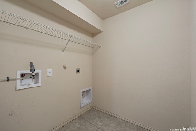 clothes washing area with electric dryer hookup, light tile patterned floors, hookup for a washing machine, and gas dryer hookup