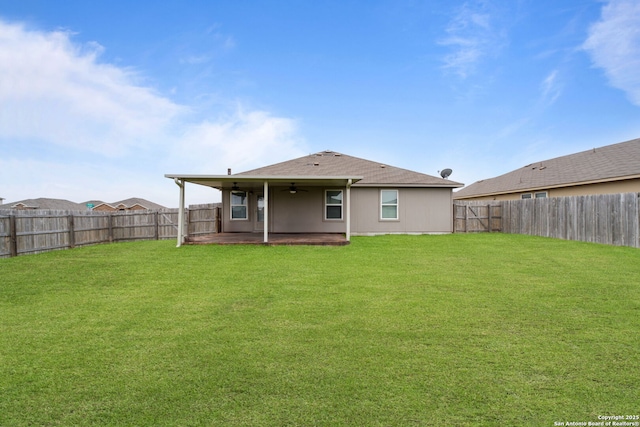 back of property featuring a yard and a patio