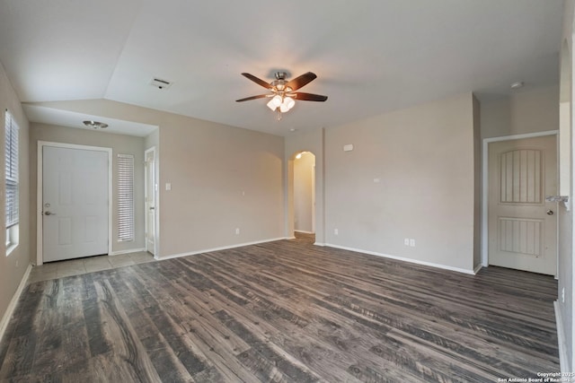 spare room featuring lofted ceiling, dark hardwood / wood-style floors, and ceiling fan