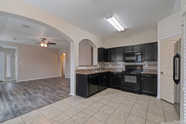 kitchen featuring ceiling fan, tasteful backsplash, light stone countertops, black appliances, and light tile patterned flooring