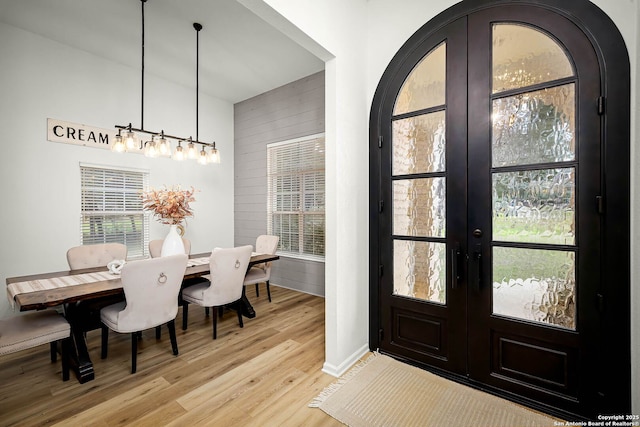 foyer with french doors and light hardwood / wood-style flooring