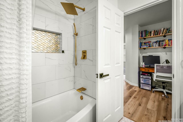 bathroom featuring tiled shower / bath combo and hardwood / wood-style floors