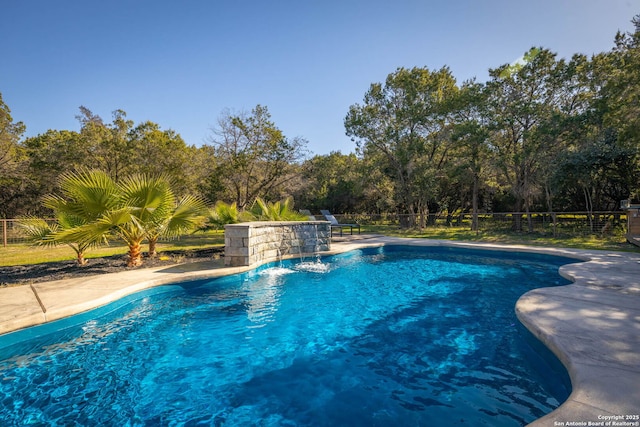 view of pool with pool water feature and a patio area