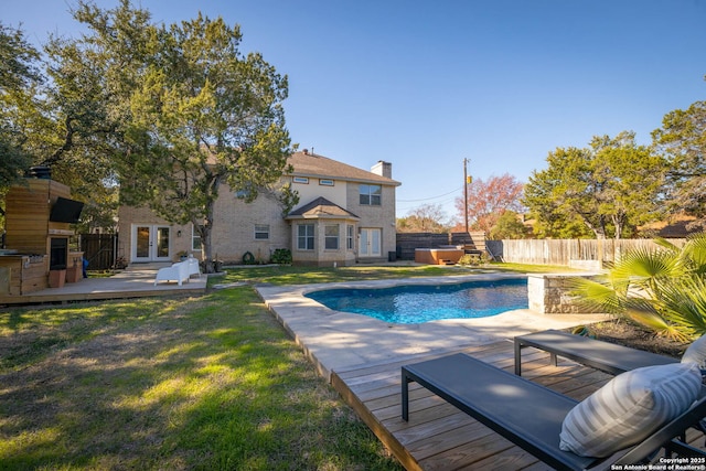 view of pool featuring a wooden deck and a yard