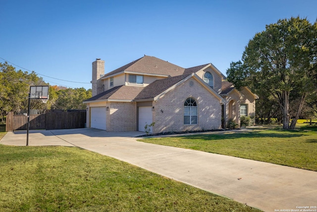 view of front of property with a garage and a front lawn