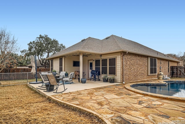 back of house with a fenced in pool, a patio area, and ceiling fan