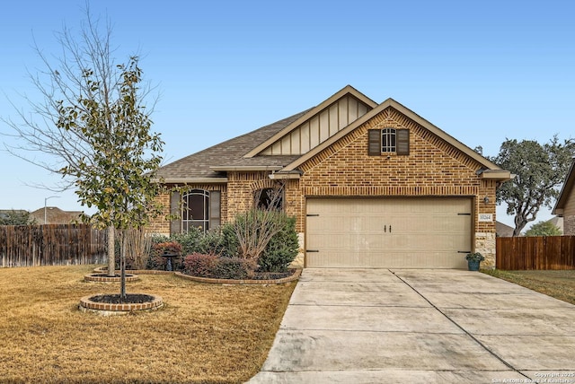 view of front of home featuring a garage and a front yard