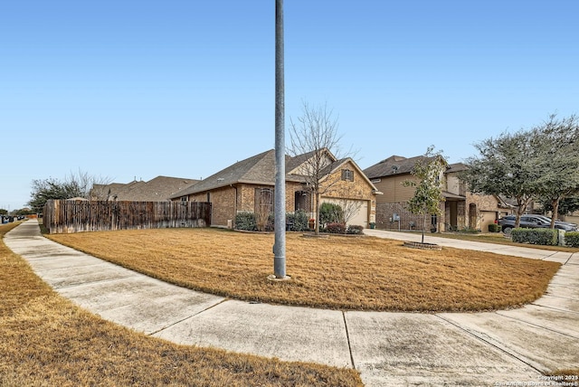 view of front facade featuring a garage and a front yard