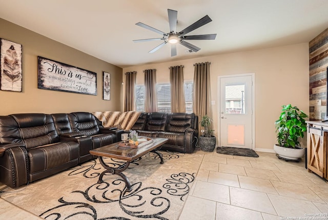 living room featuring ceiling fan and light tile patterned floors