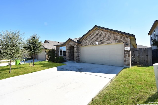 ranch-style home with a garage and a front yard